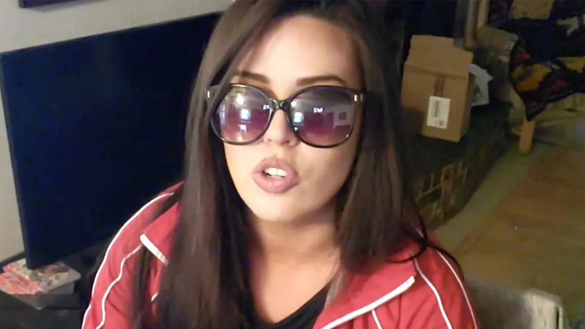 Woman wearing oversized sunglasses indoors