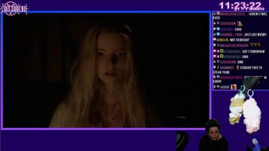 Woman in dark room on live stream.