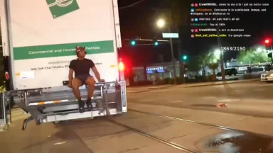 Man sitting on moving truck lift at night
