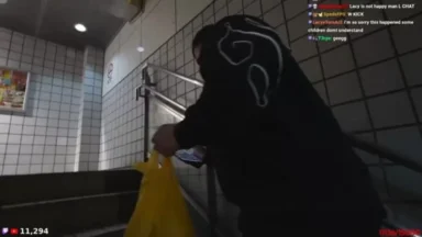 Streamer carries yellow bag down tiled stairwell