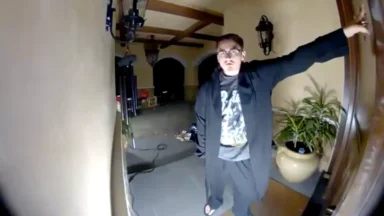 Man standing at front door at night