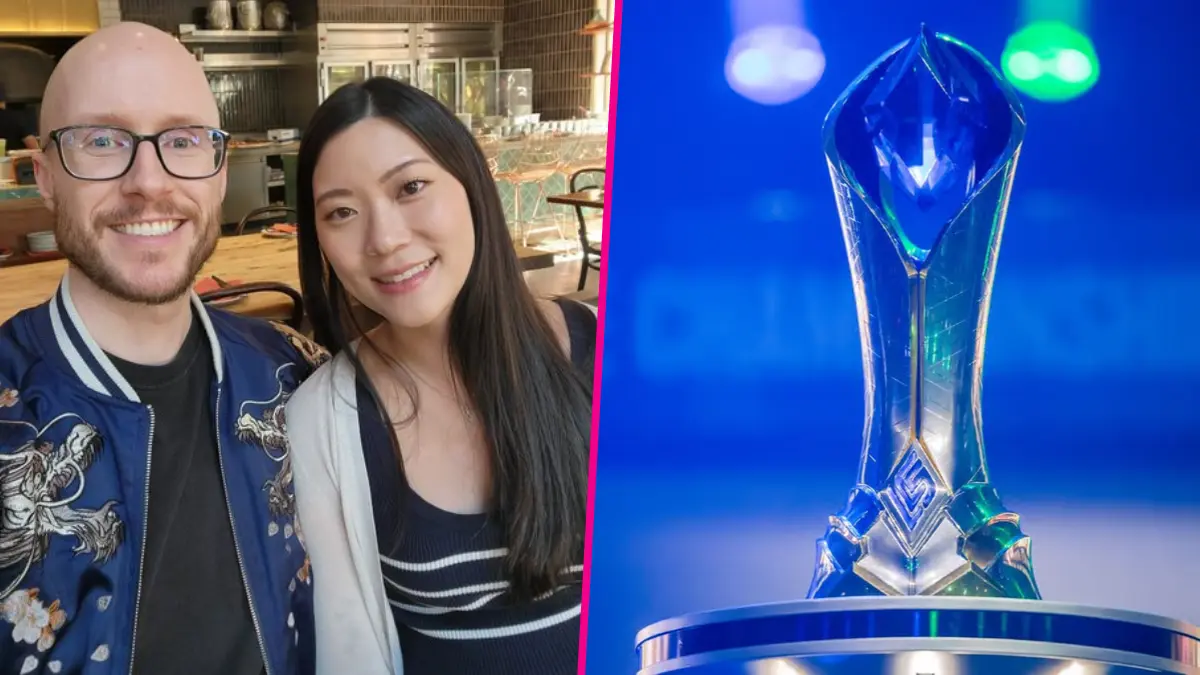 Smiling couple beside esports championship trophy