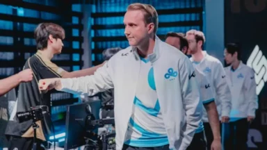 Esports player fist bumping teammate on stage