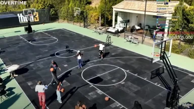 People playing basketball on outdoor court