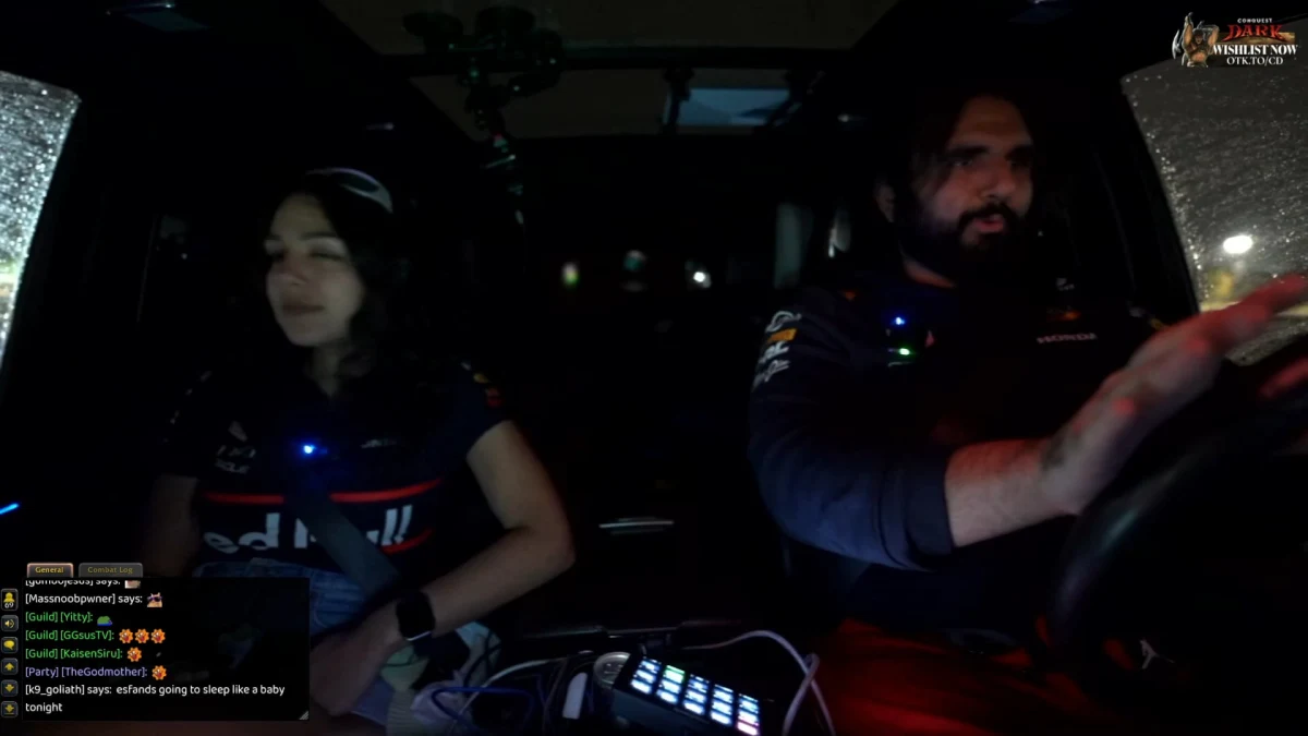 Two people driving at night in a car