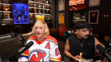 Two men recording a podcast in a sports-themed studio