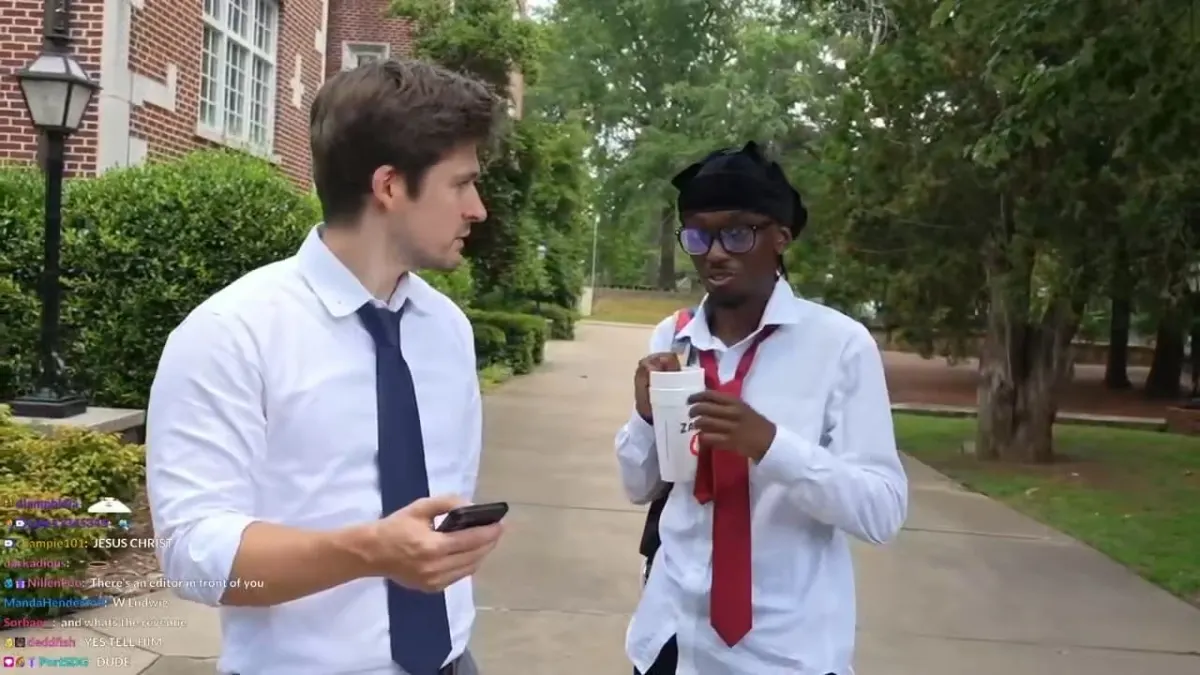 Two men talking on a college campus walkway