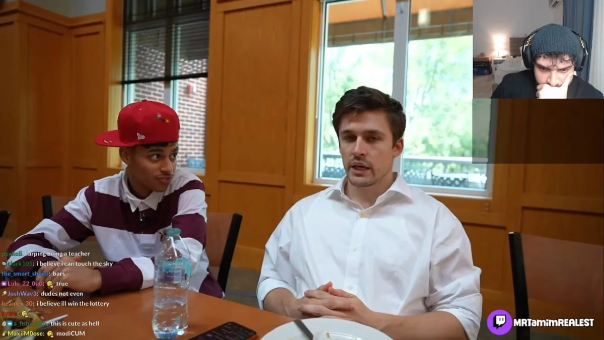 Two men seated at table during livestream discussion
