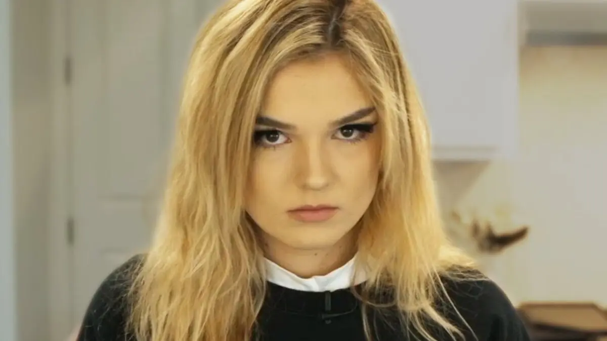 Close-up portrait of blonde woman with dramatic eye makeup