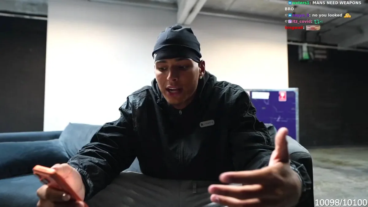 Man speaking passionately while holding smartphone indoors