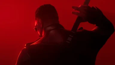 Man holding bat over shoulder in red light