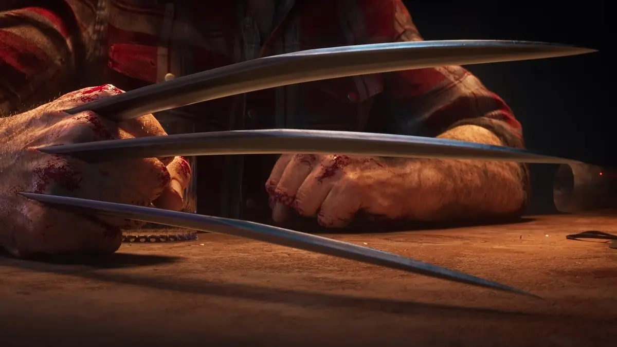 Bloodied hands with metal claws on table
