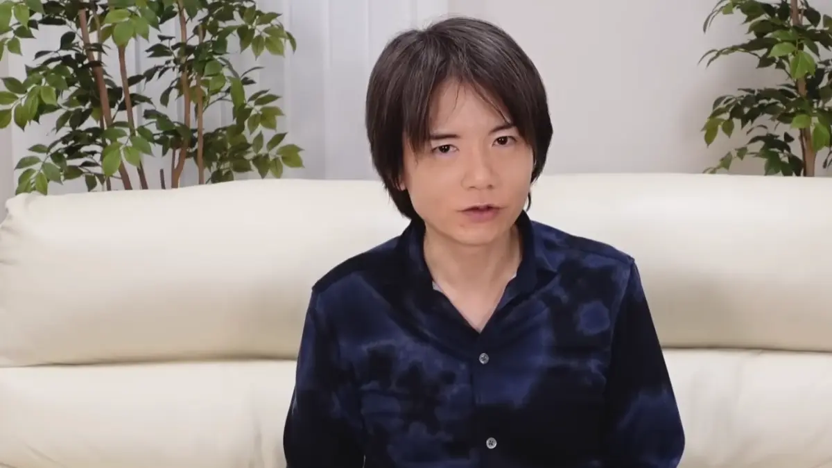 Person sitting on couch with plants behind.