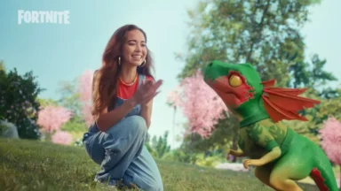 Woman kneeling beside small green dragon character