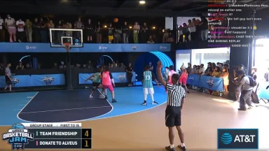 Indoor basketball game with audience watching intensely.