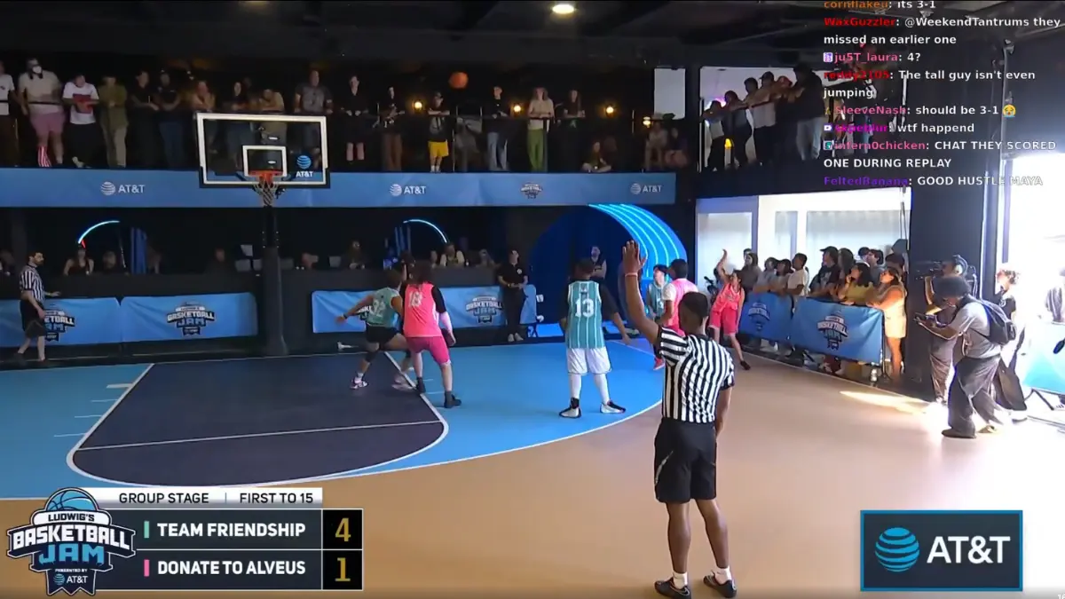 Indoor basketball game with audience watching intensely.