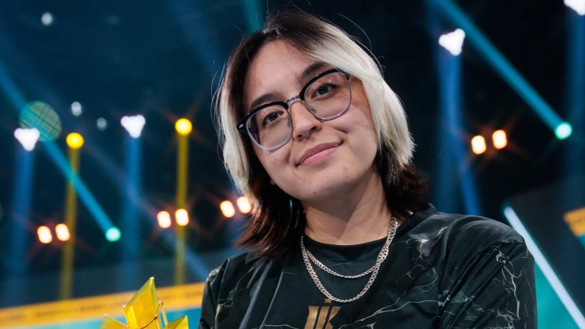 Smiling woman with glasses under colorful stage lights