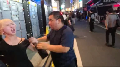 Man and woman interacting on a busy nighttime street