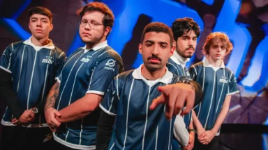 Five esports players in matching blue jerseys pose together