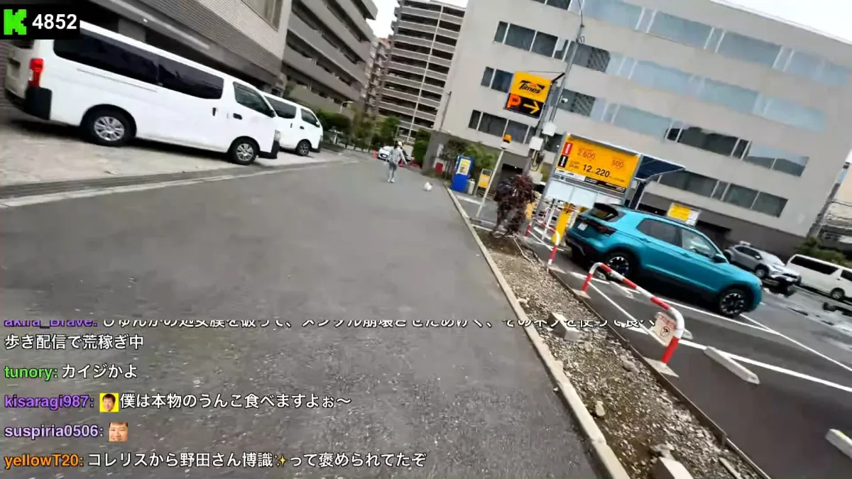 Urban street with parking lot and teal SUV