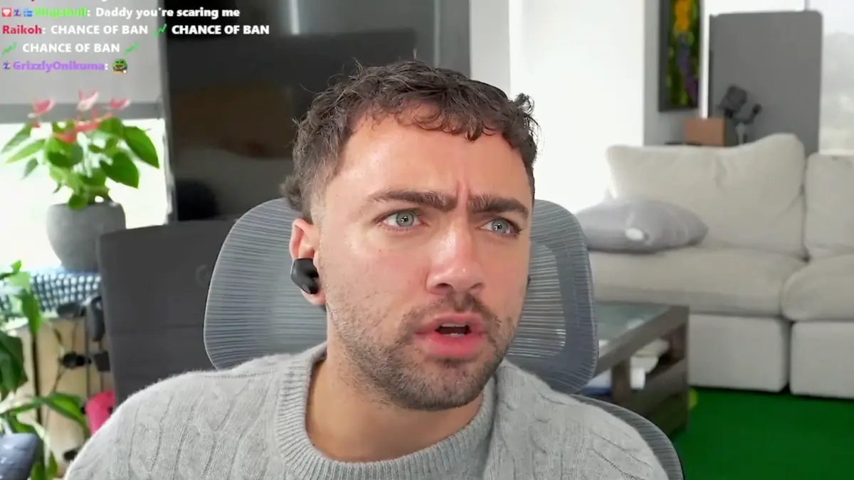 Man wearing earbuds looks concerned during livestream