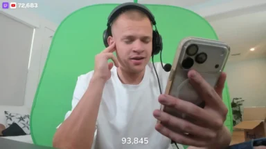 Man streaming with headset in front of green screen