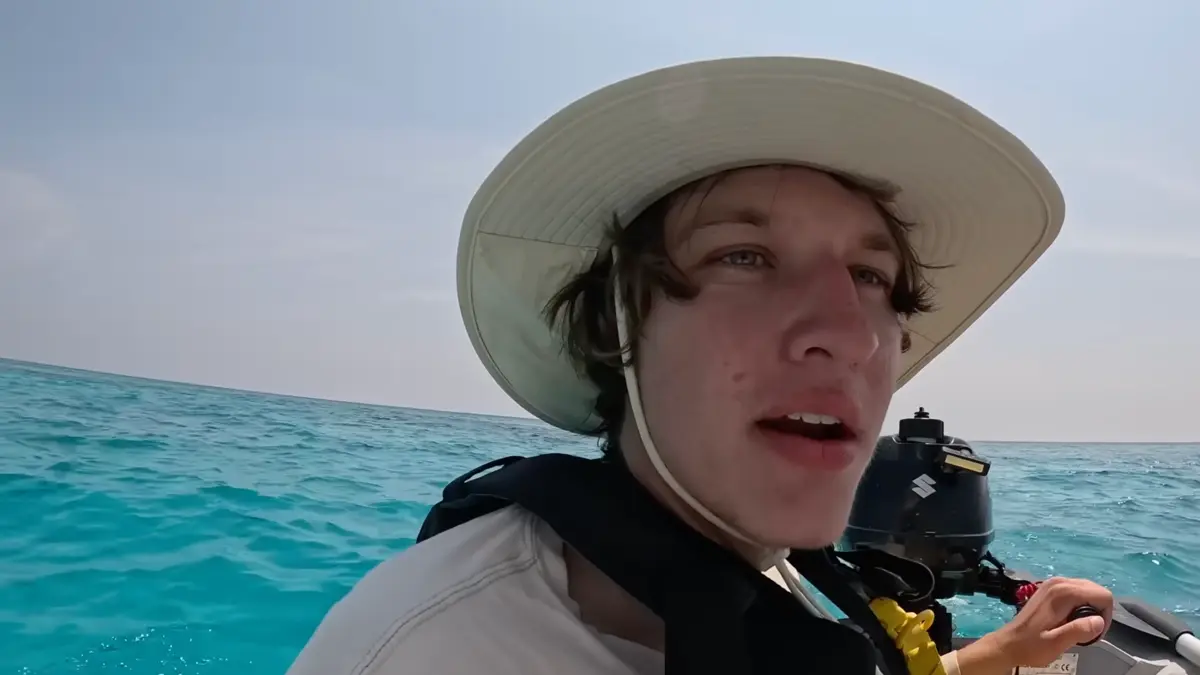 Person wearing sun hat on boat in ocean