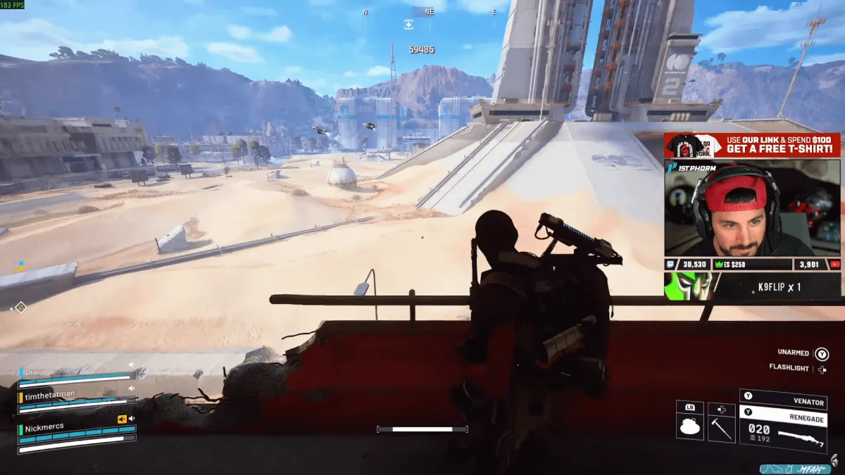 Gamer streaming first-person shooter in desert environment