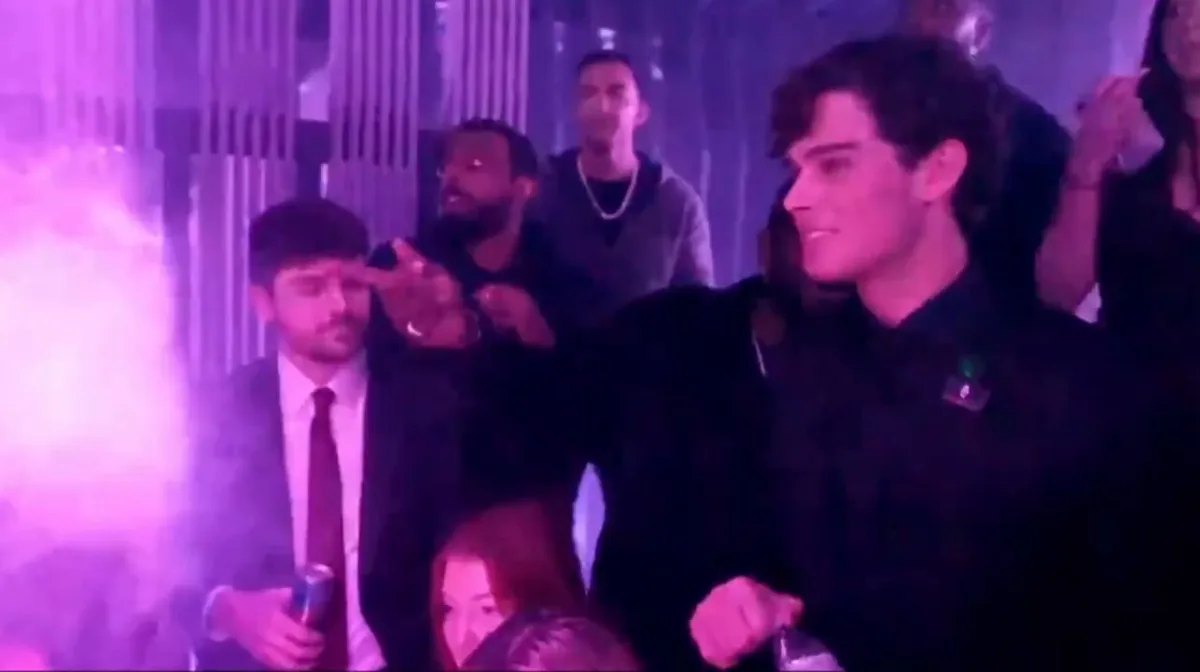 People dancing in a nightclub with purple lights