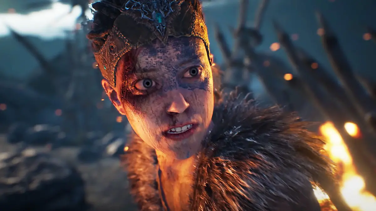 Warrior woman with face paint beside flames