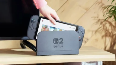 Hand placing Nintendo Switch 2 into dock