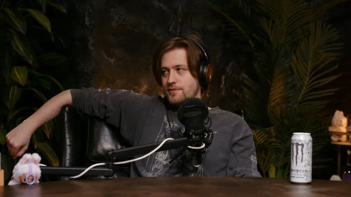 Man wearing headphones speaking into podcast microphone