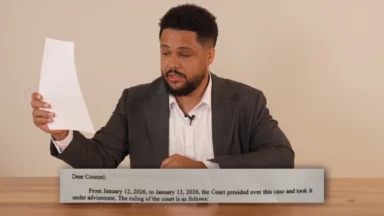 Man in suit reading court ruling document