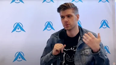 Man speaking into microphone during interview