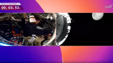 Astronauts inside spacecraft with Moon view outside