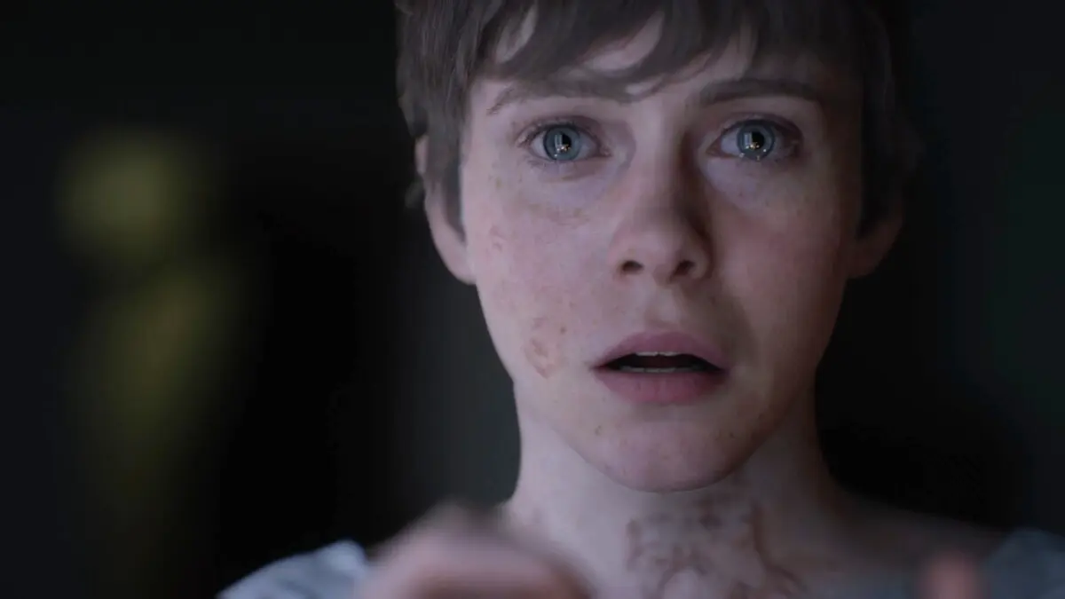 Person looking shocked in a dark room