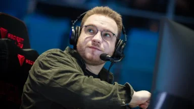 Man wearing headset and glasses at esports computer