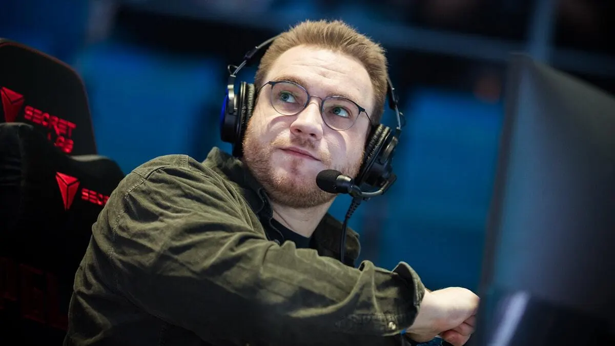 Man wearing headset and glasses at esports computer