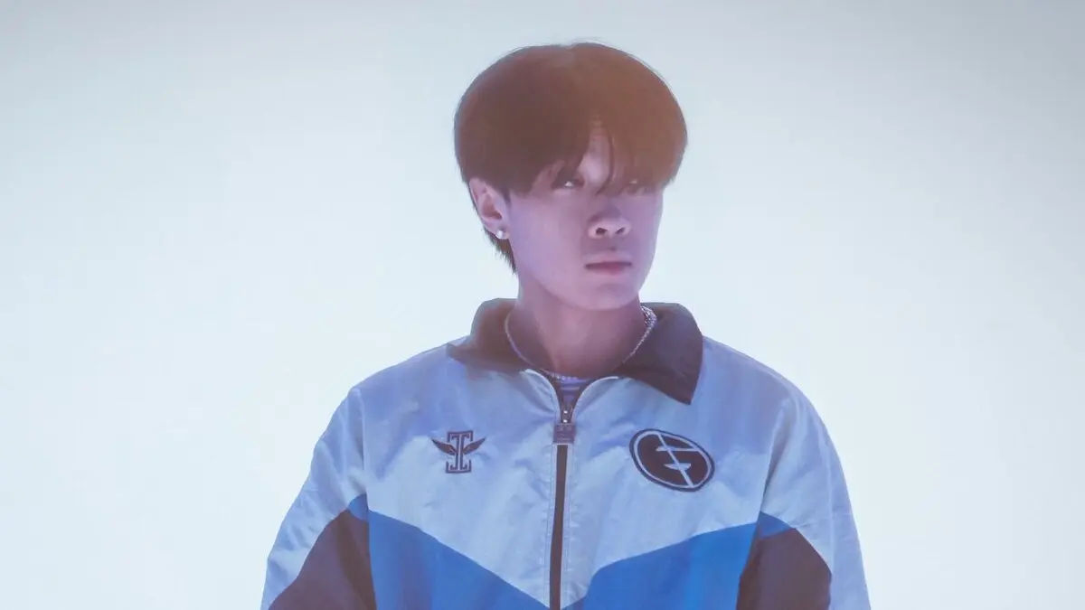 Young man in blue jacket looking sideways