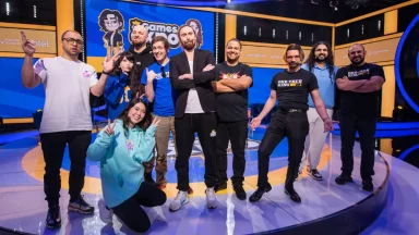 Group of people on a stage smiling.