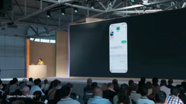 Presenter demonstrates messaging app on large conference screen