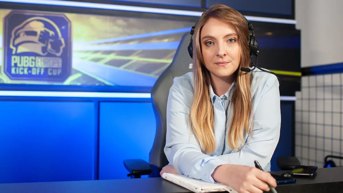 Esports commentator wearing headset at PUBG Kick-Off Cup desk