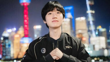 Young man posing before city skyline at night