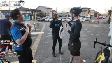 Cyclists talking on suburban street during livestream event