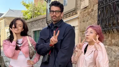 Three friends posing with peace signs outdoors