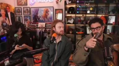 Three people recording podcast in a decorated studio