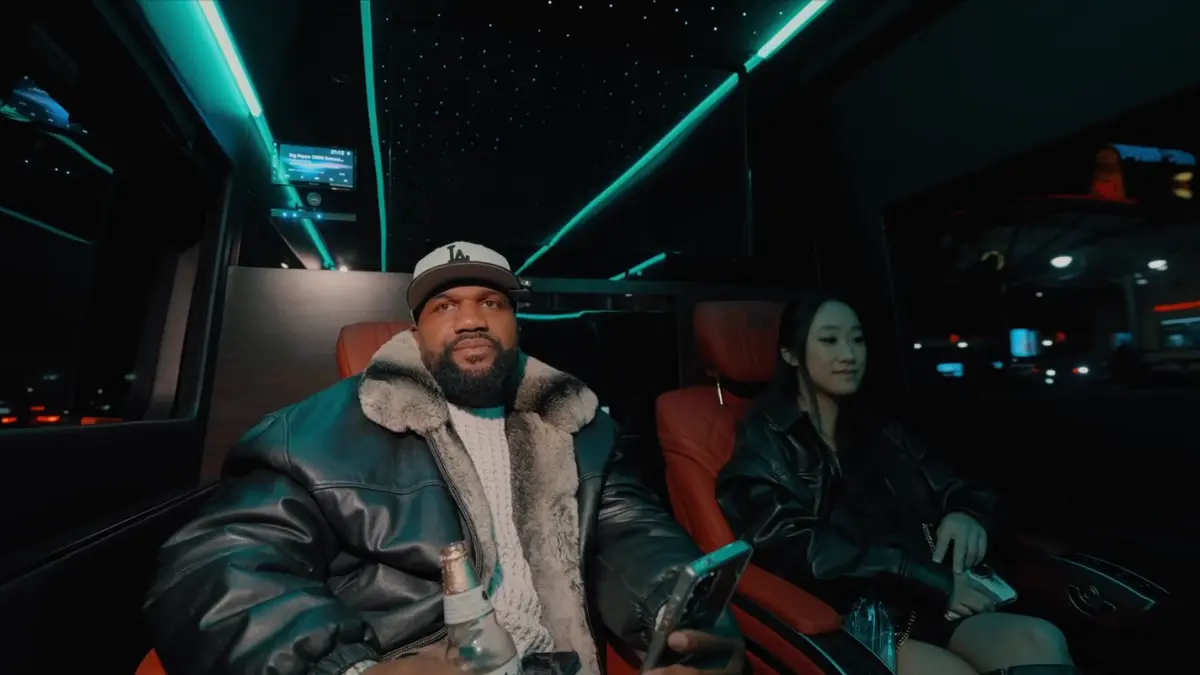 Man and woman sitting in luxury car at night