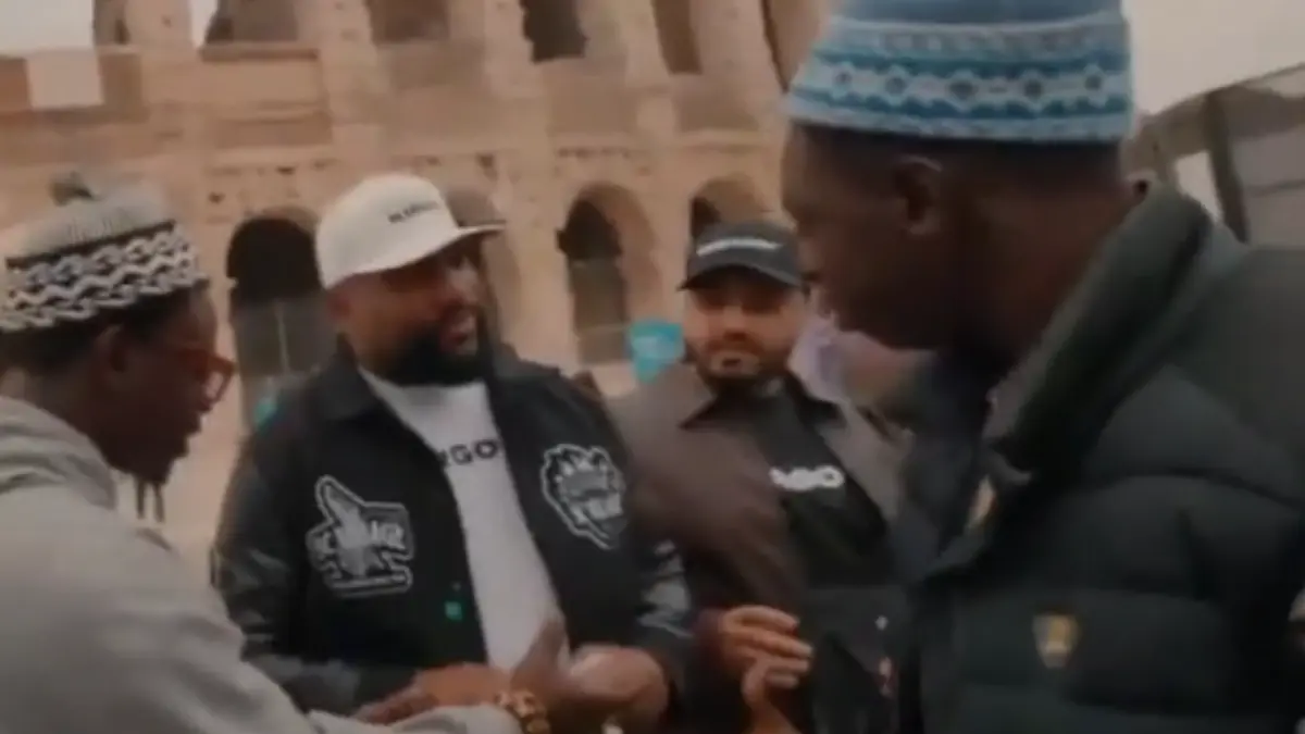 Group of men talking near ancient stone building