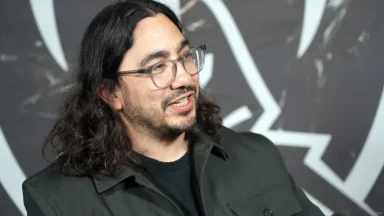 Man with glasses speaking at event