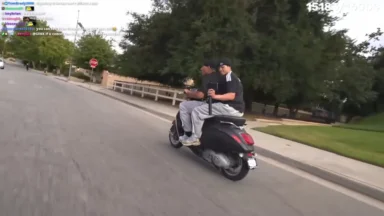 Two men riding scooter on suburban street